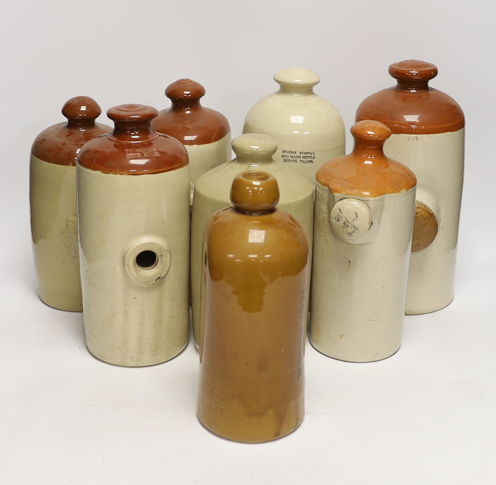 Eight various stoneware hotwater bottles, early 20th century, largest 30cm high